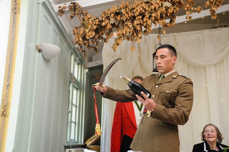 Pefect sabrage by bride's son in his military uniform